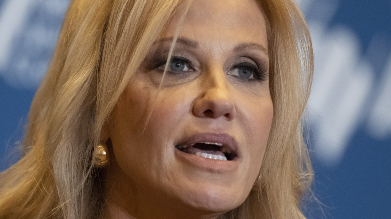 Kellyanne Conway speaks into a microphone at a conference