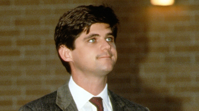 Young William Kennedy Smith standing outside a courthouse
