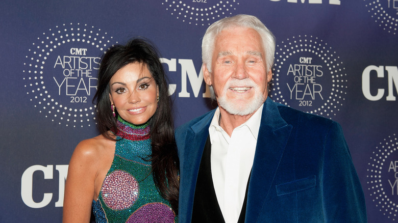 Wanda Miller and Kenny Rogers smiling at an event in 2013.