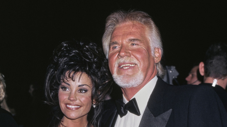 Wanda Miller and Kenny Rogers smiling in 1999.