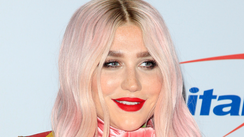 kesha wearing red lipstick and sporting pink hair 