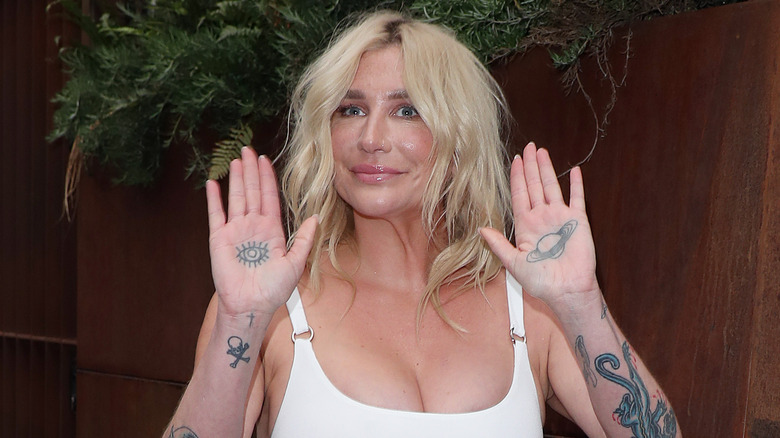 Kesha smiling, showing tattoos