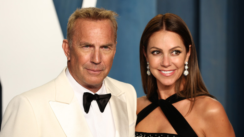 Christine Baumgartner and Kevin Costner posing for photos