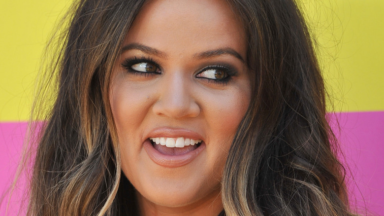 Khloe Kardashian smiles on the red carpet.