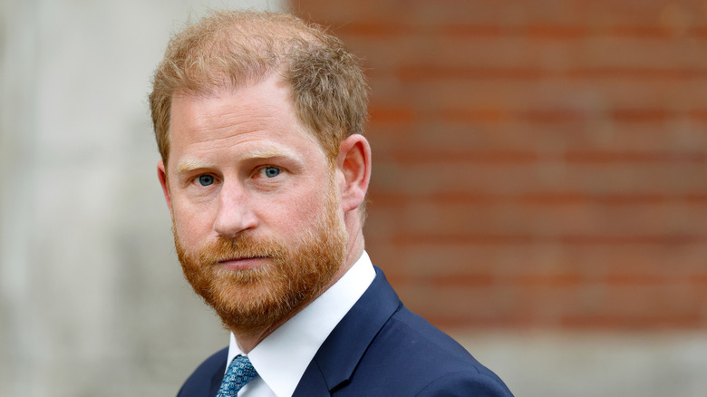 Prince Harry looks past the camera