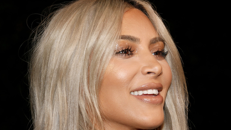 Kim Kardashian laughing with blonde hair