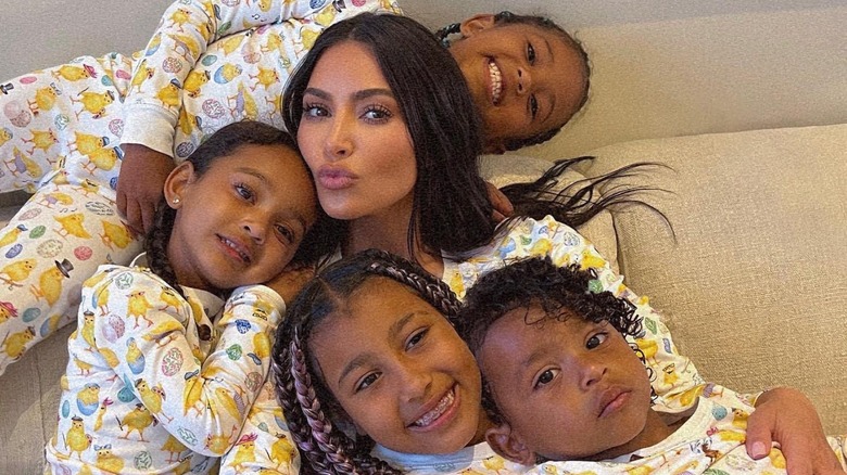 Kim Kardashian holding her four kids