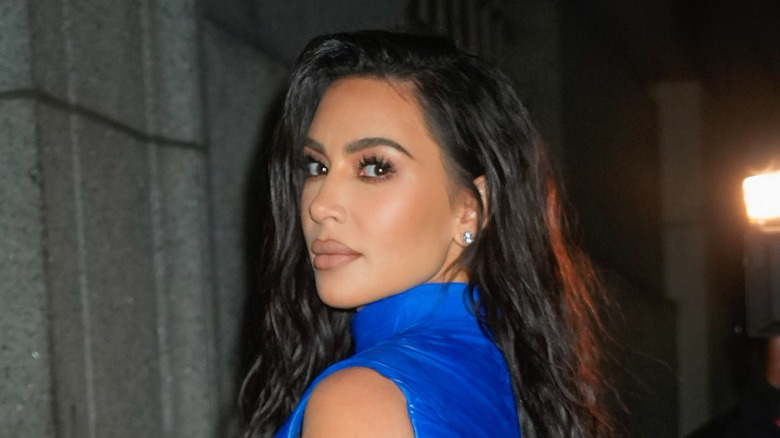 Kim Kardashian scowling in blue top