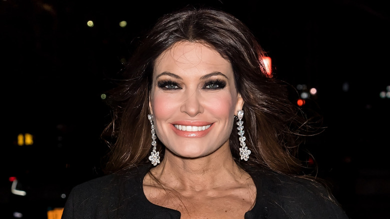 Kimberly Guilfoyle smiling in a black dress at the Chiara Boni La Petite Robe Fashion show.