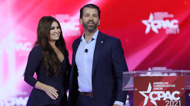 Kimberly Guilfoyle and Donald Trump Jr. stand onstage at an event