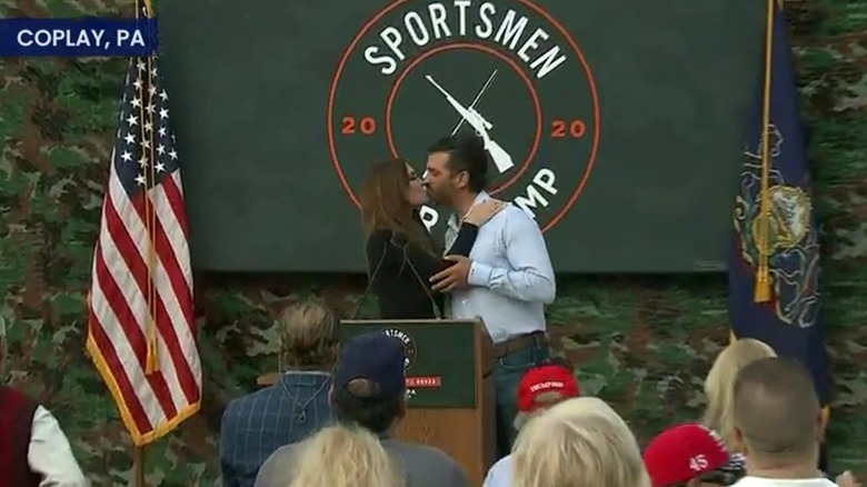 Donald Trump Jr. grabbing Kimberly Guilfoyle's elbow while kissing her