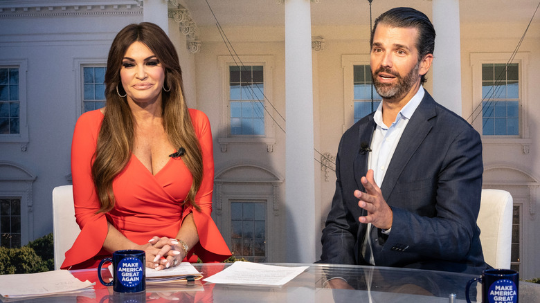 Kimberly Guilfoyle smiling next to Donald Trump Jr.