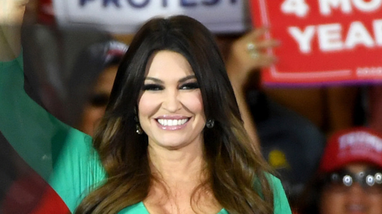 Kimberly Guilfoyle smiling in a long green dress.
