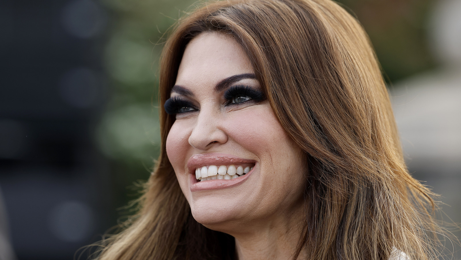 Kimberly guilfoyle ramps up glam in skin baring revenge dress amid don