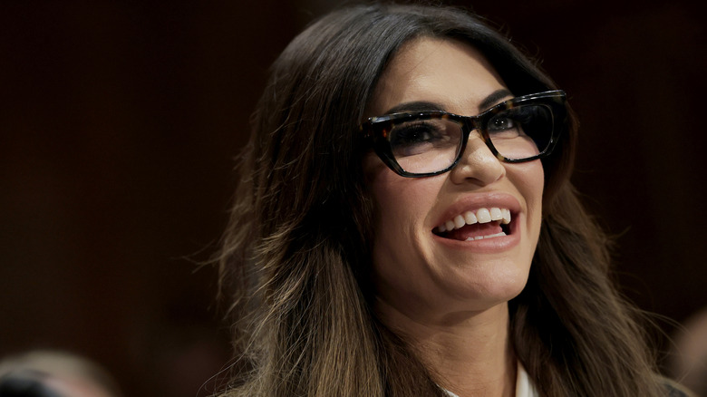 Kimberly Guilfoyle smiling in glasses with her hair loose