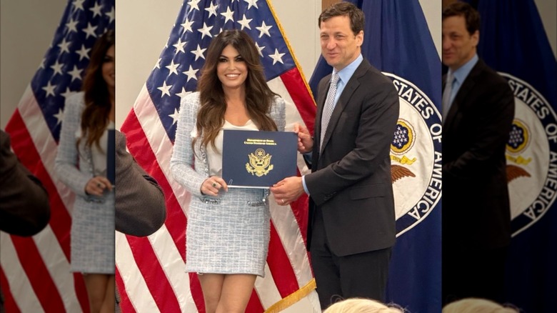 Kimberly Guilfoyle posing with diploma