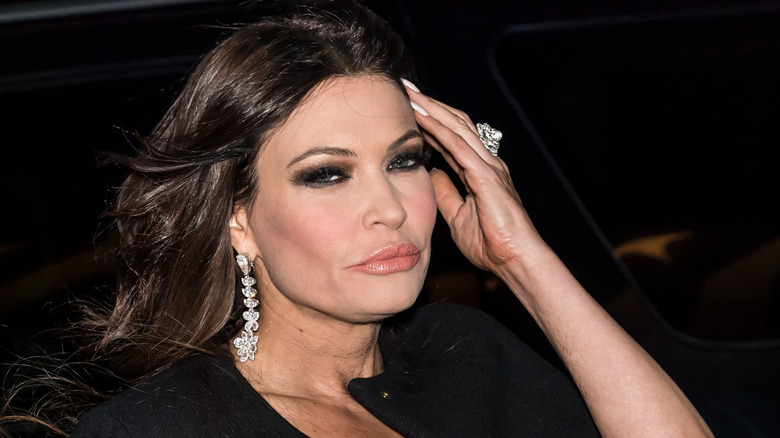 Kimberly Guilfoyle pursing her lips and putting her hand to her temple