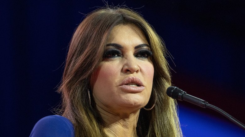 Kimberly Guilfoyle speaking on stage while wearing a blue dress.