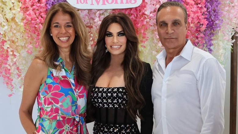 Kimberly Guilfoyle posing with two people at the Hearts for Moms event