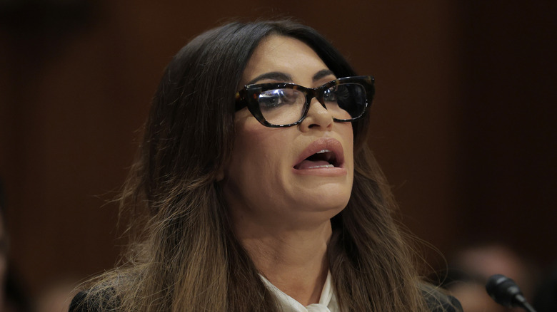 Kimberly Guilfoyle saying something into a microphone while wearing glasses