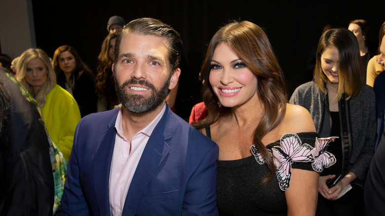 Donald Trump Jr. smiles next to Kimberly Guilfoyle