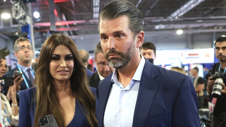 Kimberly Guilfoyle and Donald Trump Jr. in hall with reporters