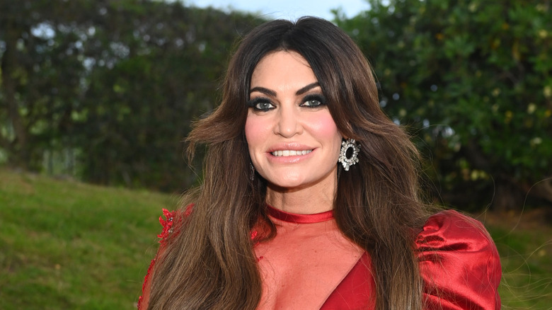 Kimberly Guilfoyle smiling in a red dress at the 2025 amfAR Gala Cannes