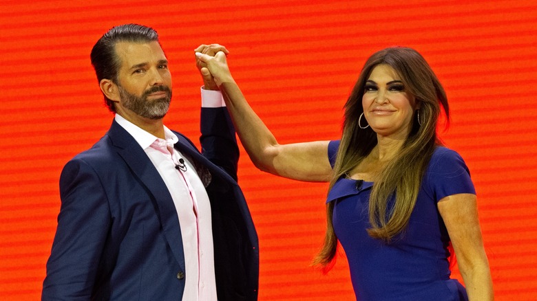 Donald Trump Jr. and Kimberly Guilfoyle clasping hands during the 2023 Conservative Political Action Conference