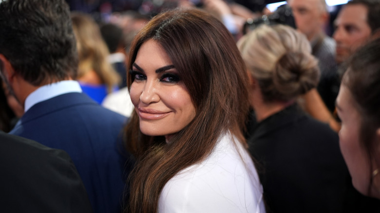Kimberly Guilfoyle looking over her shoulder and smiling at the camera at the 2024 RNC