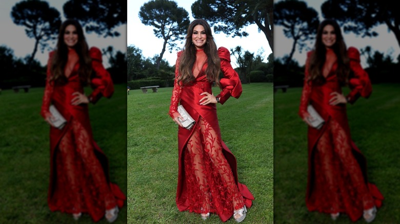 Kimberly Guifloyle poses on lawn in red gown