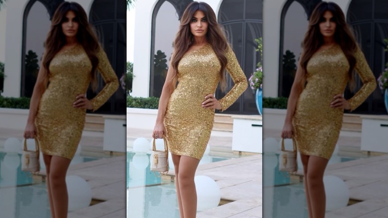 Kimberly Guilfoyle posing poolside in a sparkling gold birthday dress