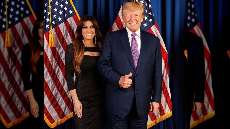 Kimberly Guilfoyle and President Donald Trump posing in front of American flags