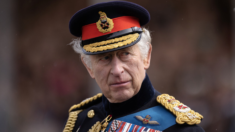 King Charles III looking over shoulder
