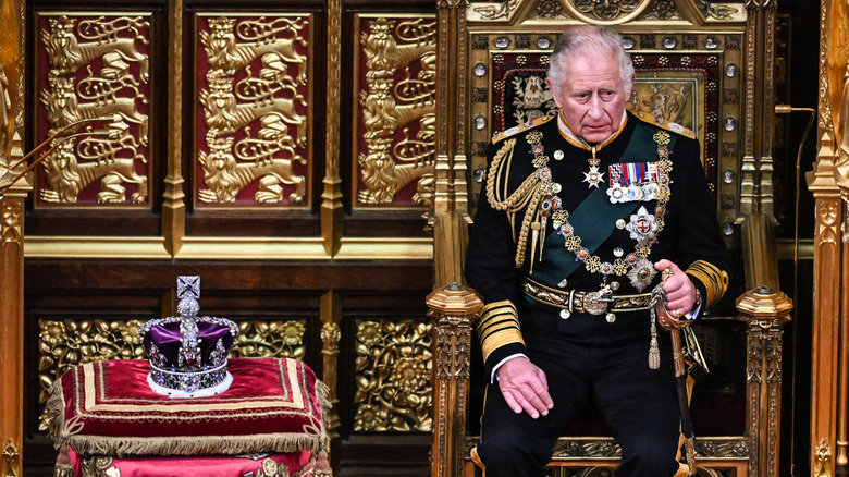 King Charles sitting on throne