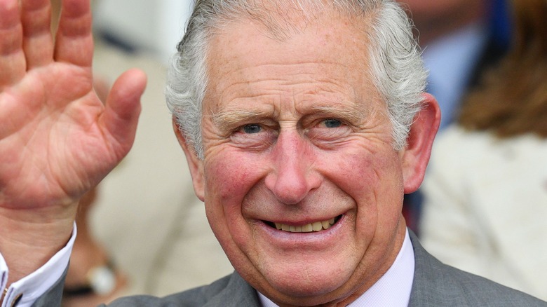 King Charles smiling and waving