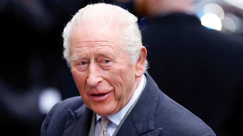 King Charles III looking off in the crowd