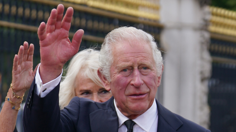 King Charles waving at Buckingham Palace