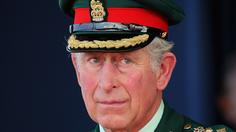King Charles looking serious in uniform