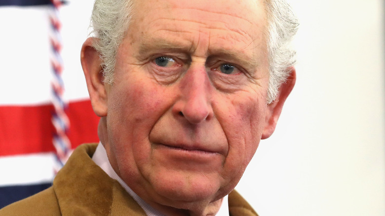 King Charles III looking grumpy at event