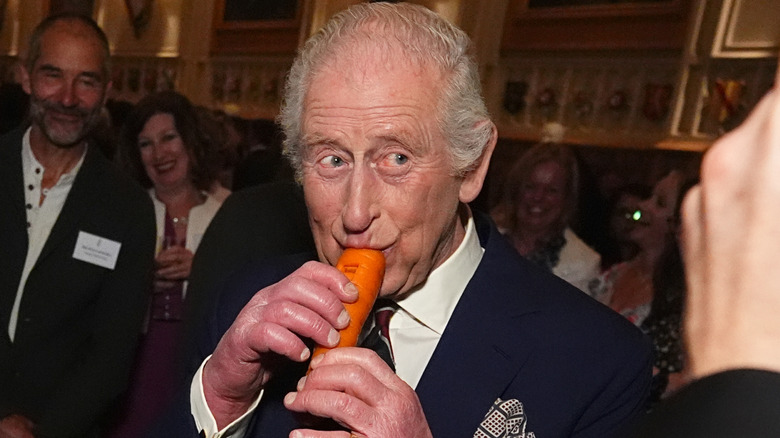 King Charles III playing a carrot-shaped instrument