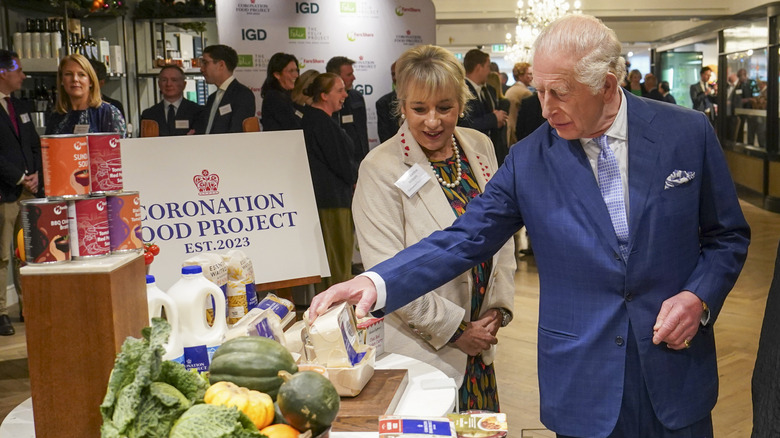 King Charles III examining a food display