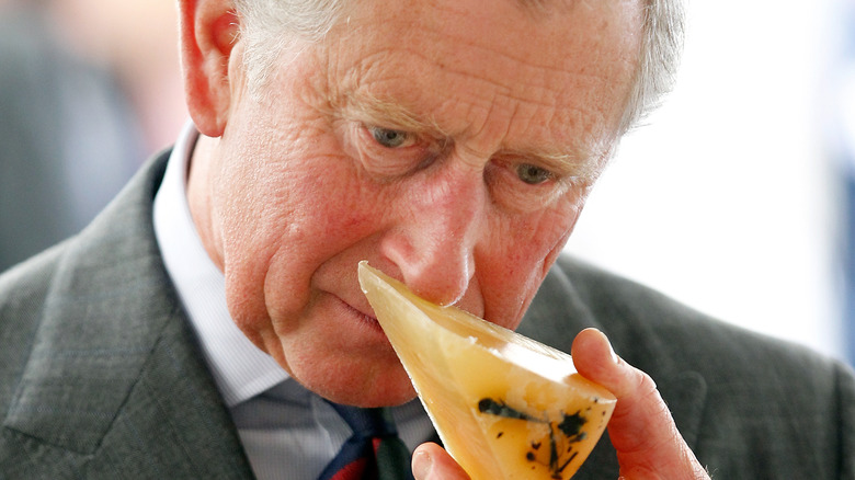 King Charles smelling cheese