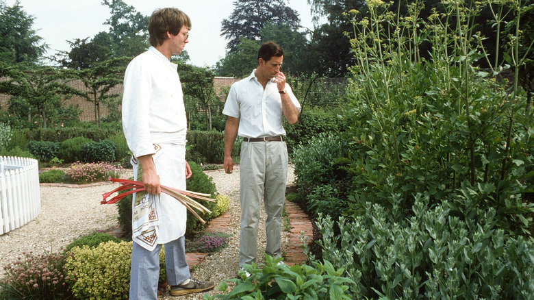 King Charles walking with his chef at a garden at Highgrove House