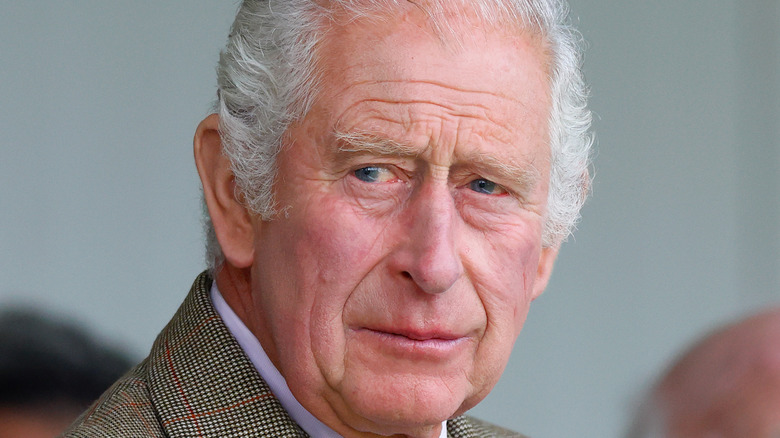 King Charles III frowning