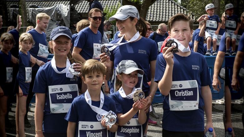 Denmark's Prince Christian, Princess Isabella, Prince Vincent, and Princess Josephine hold up their medals after the Royal Run in 2018