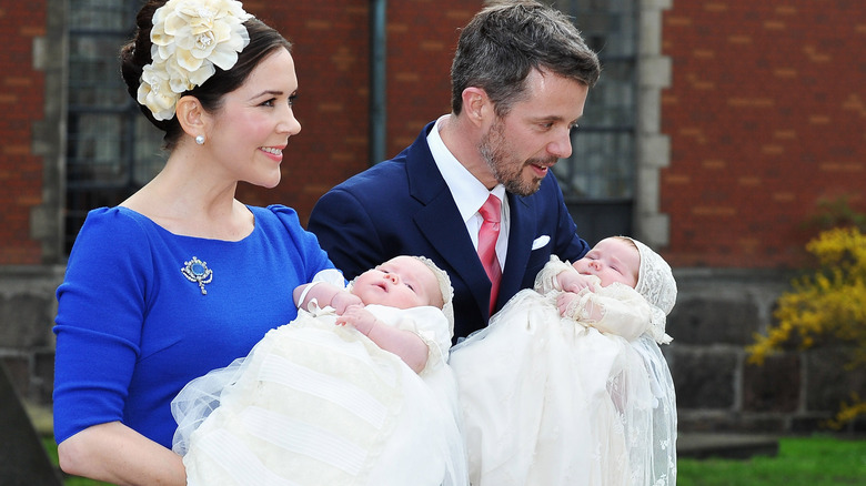 King Frederik and Queen Mary hold their twins, Prince Vincent and Princess Josephine, on their baptism.