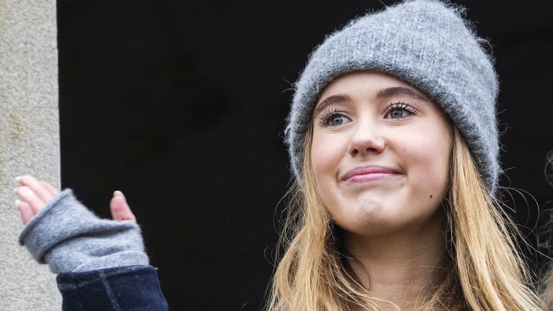Princess Josephine of Denmark smiles and waves outside of the royal palace in 2024