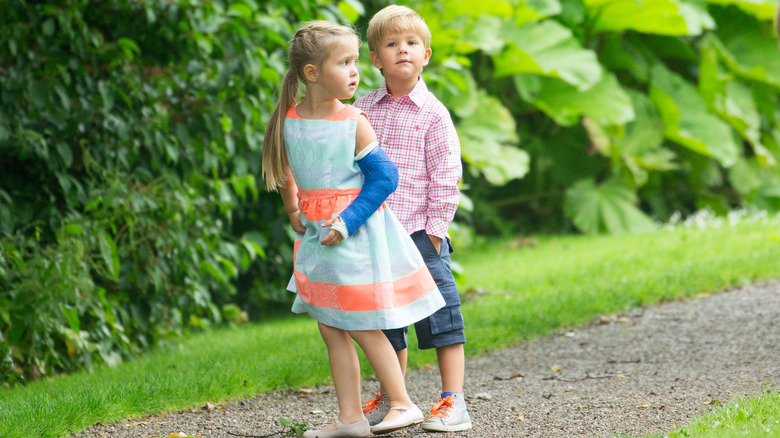 Prince Vincent and Princess Josephine walk outside while Josephine's arm is in a cast