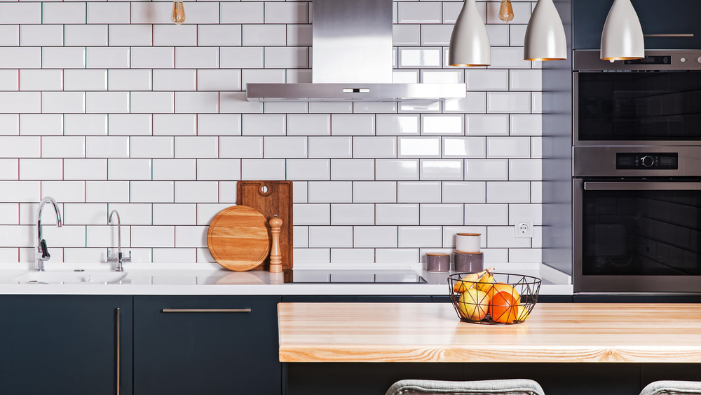 Navy blue kitchen cabinets, white subway tile