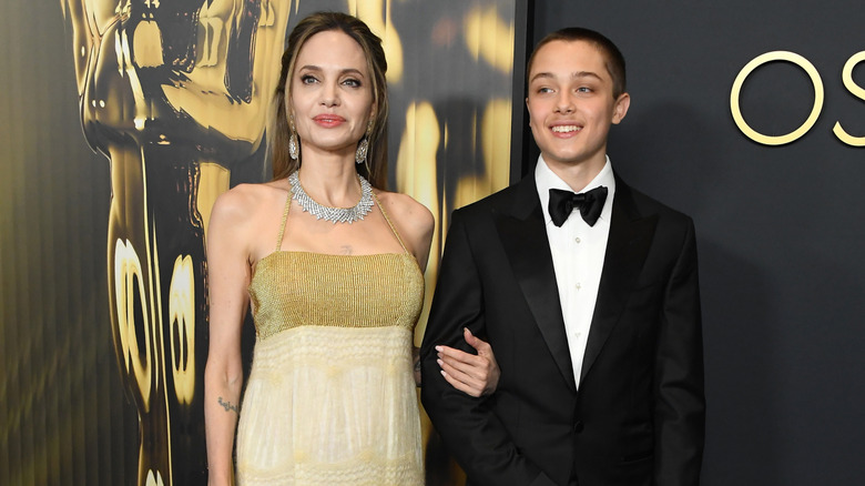Angelina Jolie holds Knox Jolie-Pitt's arm